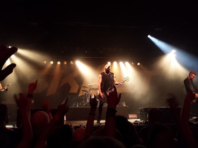 A band performing on stage in front of a crowd