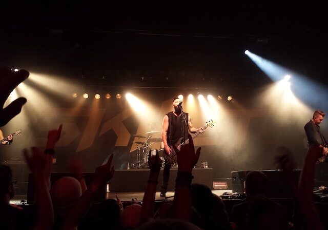 A band performing on stage in front of a crowd